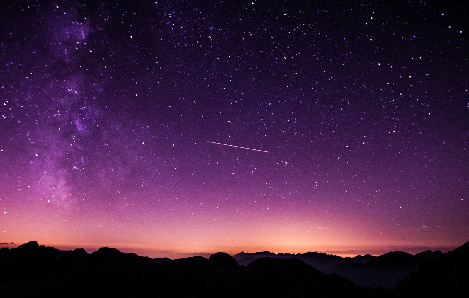 Milky Way over a dark mountain landscape